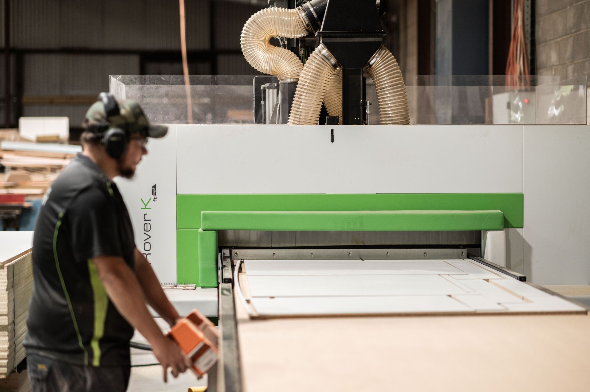 A Man is Working on a Machine in a Factory — Plumbe Joinery in Coffs Harbour, NSW