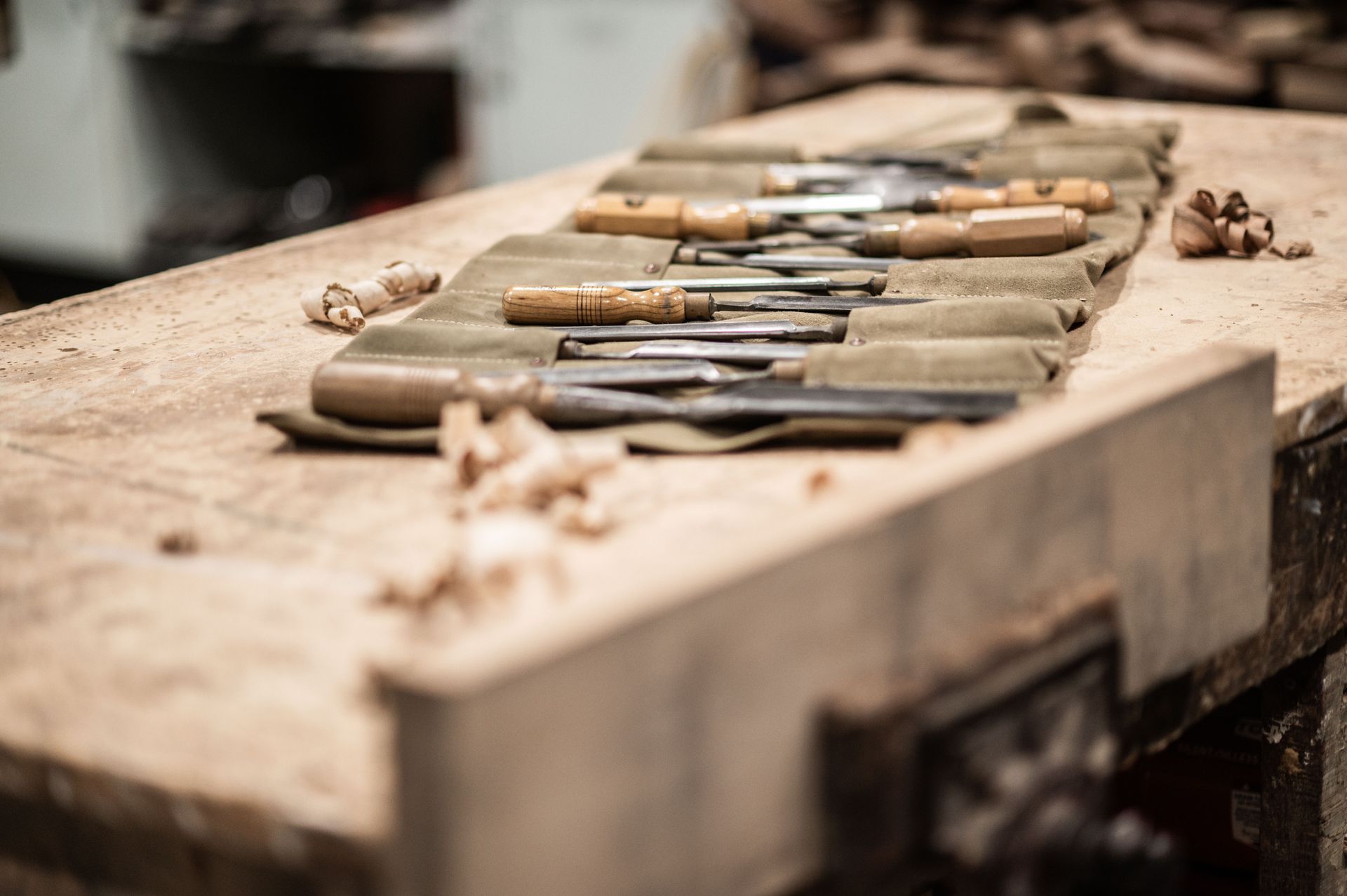 A Wooden Workbench With a Roll of Carving Tools on It — Plumbe Joinery in Coffs Harbour, NSW