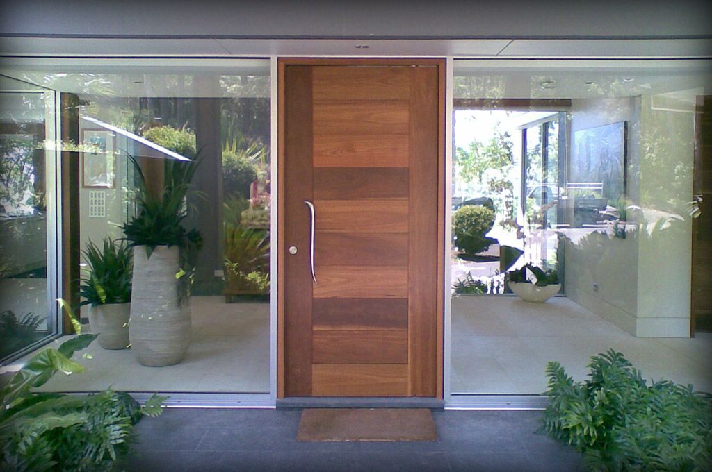 The Front Door of a House With a Wooden Door — Plumbe Joinery in Coffs Harbour, NSW
