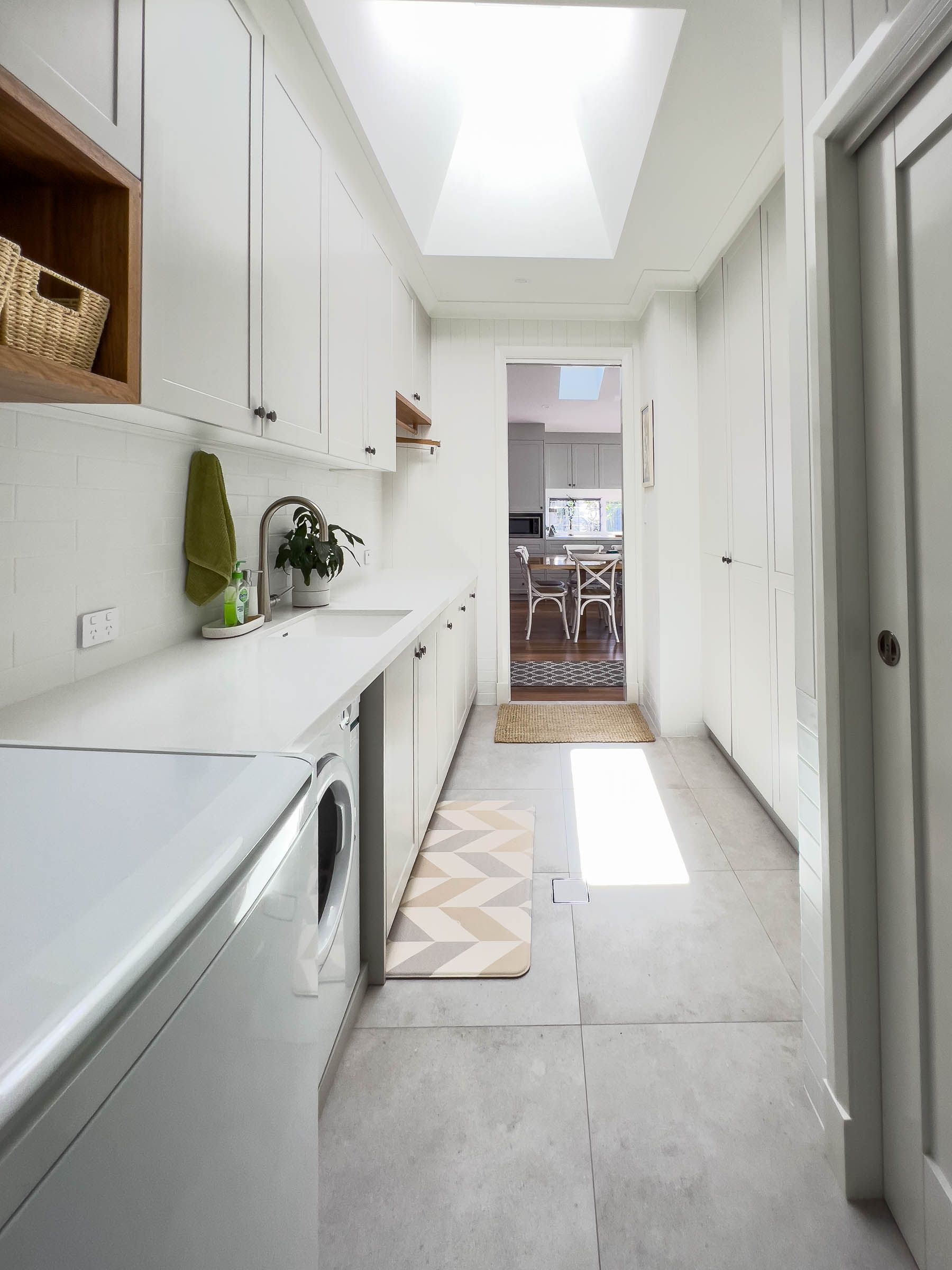 A Laundry Room With White Cabinets — Plumbe Joinery in Coffs Harbour, NSW