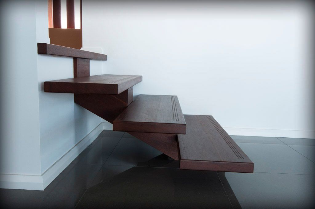 A Wooden Staircase With a White Wall Behind It — Plumbe Joinery in Coffs Harbour, NSW