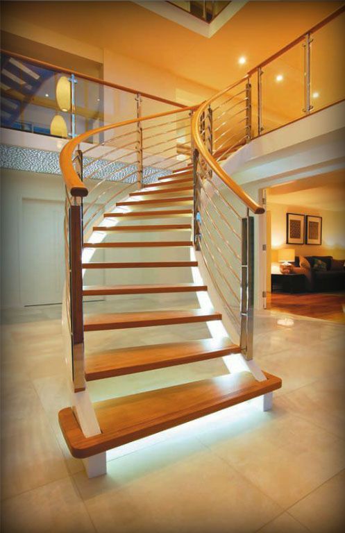 A Wooden Staircase With a Glass Railing in a House — Plumbe Joinery in Coffs Harbour, NSW