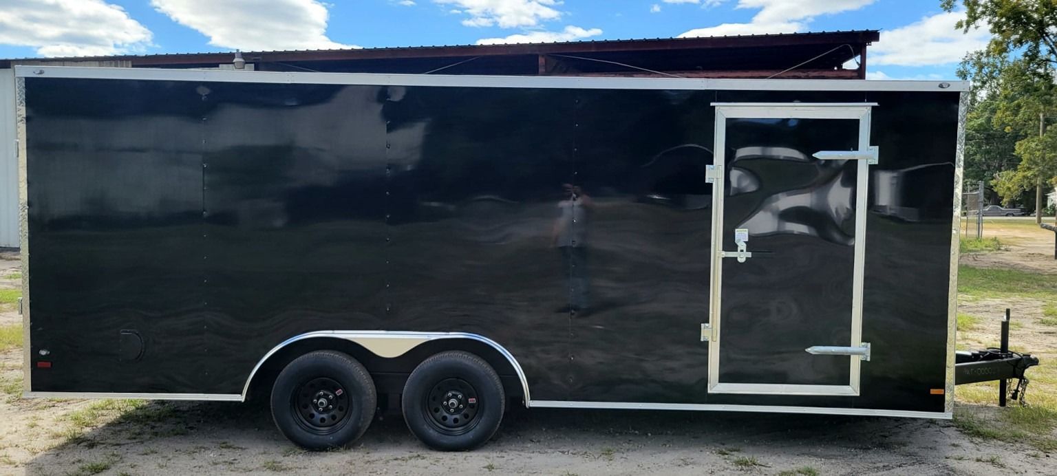 Black enclosed cargo trailer with a double axle, and a single door.