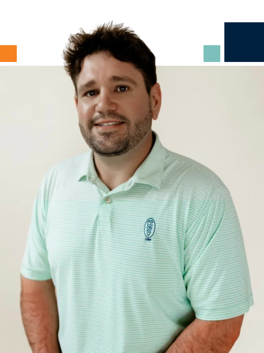 A man with a beard is wearing a suit and tie.