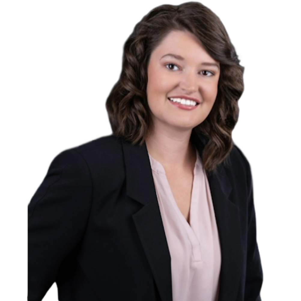 A woman wearing a black jacket and a pink shirt is smiling