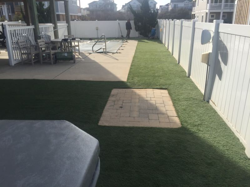 Artificial turf surrounding pool. Often used so grass clippings don't get into pool.