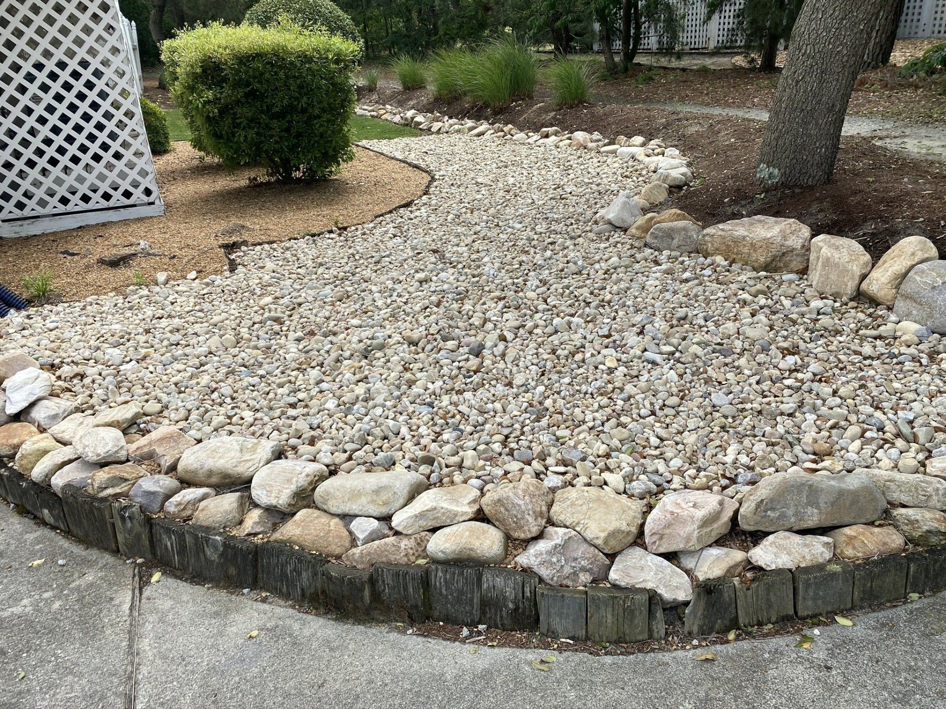 Number 3 rock bordered by cobblestone river rock.