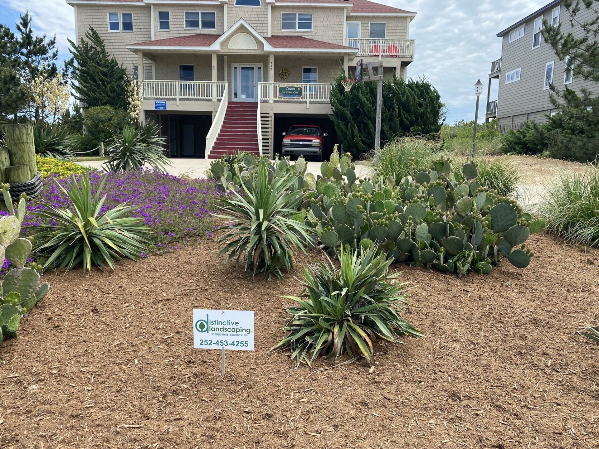 Large home with manicured professional garden and decorative landscaping