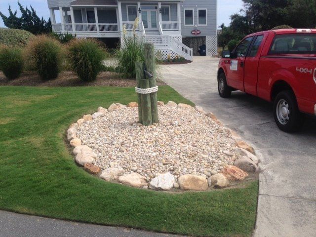 Nautical post in cobblestone number 3 rock bed with a cobblestone border.