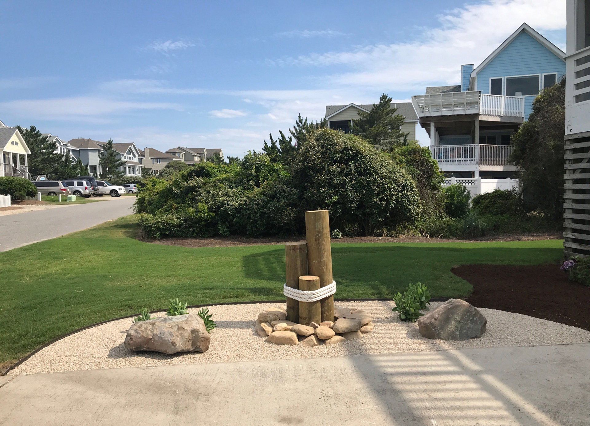 Round piling surrounded by large river rocks and then pea rocks surrounding that.

