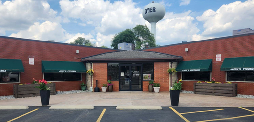 Close-up of pizza with tomatoes, mushrooms, and white cheese.