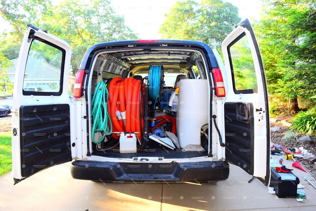 The back of a van is filled with tools and equipment.