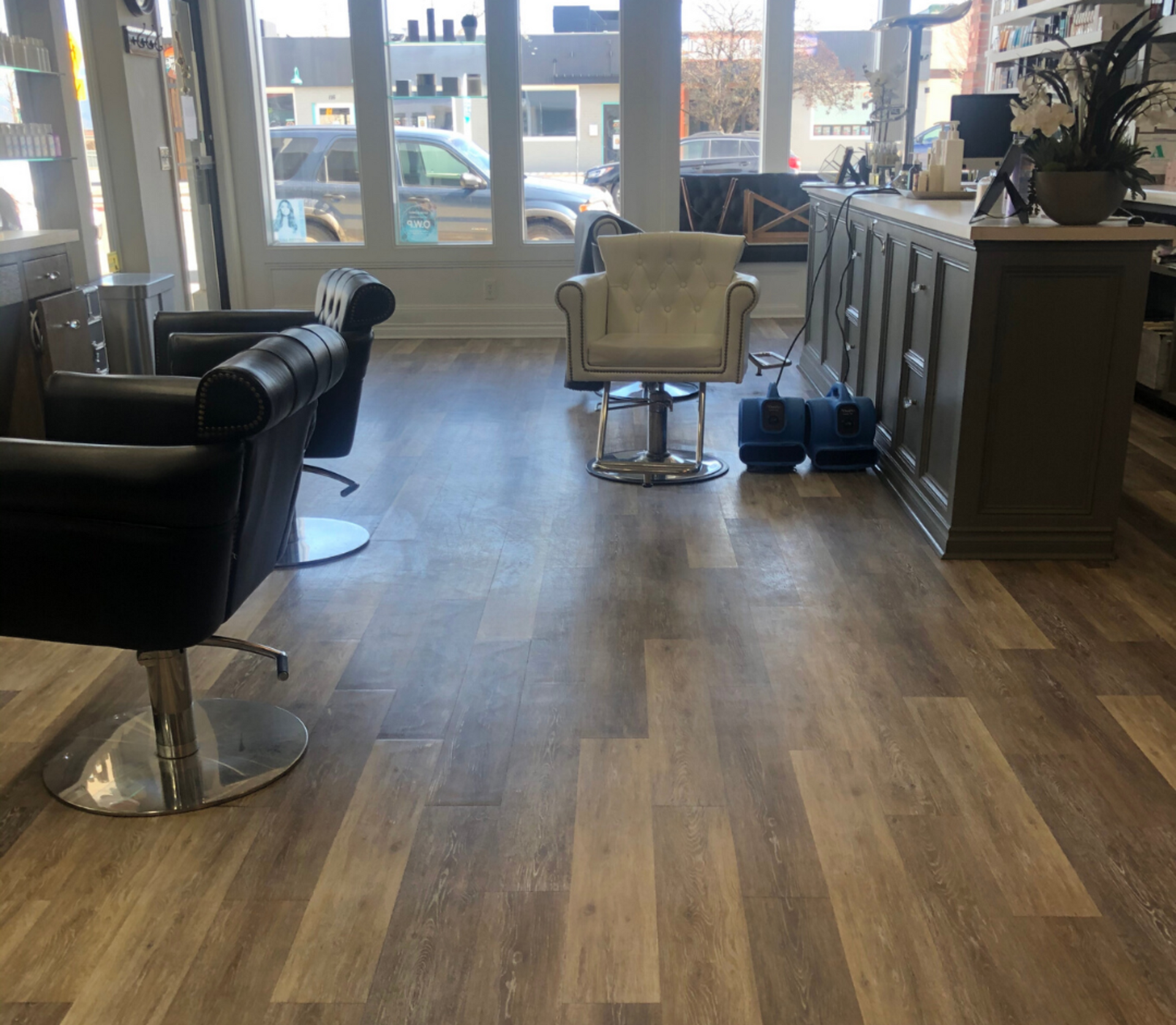 A salon with wooden floors and chairs by xtreme carpet