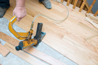 In this image, San Jose Flooring Pros is expertly installing new hardwood planks using a flooring nailer. The precision and expertise displayed in laying these elegant and durable wood flooring san jose ca is evident in the meticulous attention to detail shown by the installer. Each nail is strategically placed to ensure a secure floor installation san jose. This process requires a high level of skill and experience to achieve a flawless result. The craftsmanship involved in this installation is a testament to the dedication and commitment of the installer to creating a high-quality flooring solution for their client.