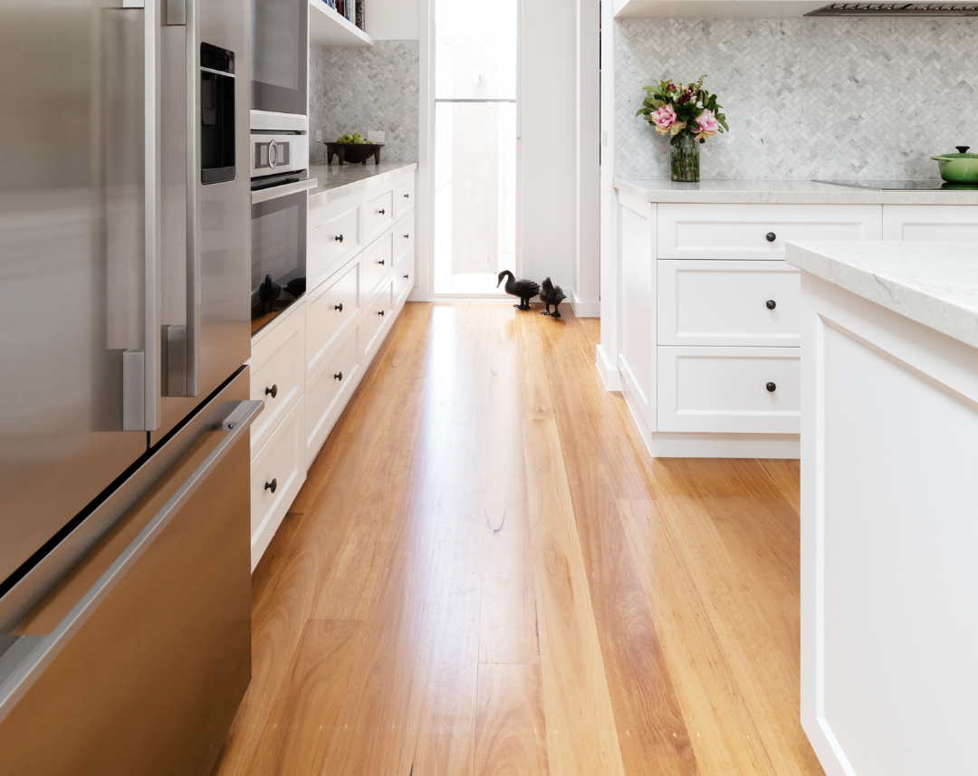 This elegant kitchen, expertly designed by San Jose Flooring Pros, showcases a seamless blend of classic design and modern amenities. The warm, natural hardwood floors from San Jose hardwood floors run throughout the space, providing a beautiful contrast to the crisp white cabinetry and stainless steel appliances. The durability and timeless appeal of the hardwood flooring make it a perfect choice for those looking to enhance the heart of their home with both beauty and practicality. San Jose Flooring Pros also offers hardwood floor refinishing in San Jose, ensuring that your floors will look as stunning as the day they were installed. Experience the perfect combination of style and functionality with San Jose flooring.