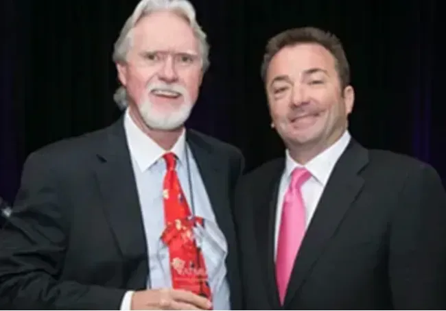 Attorney Ford standing with another man while receiving an award.