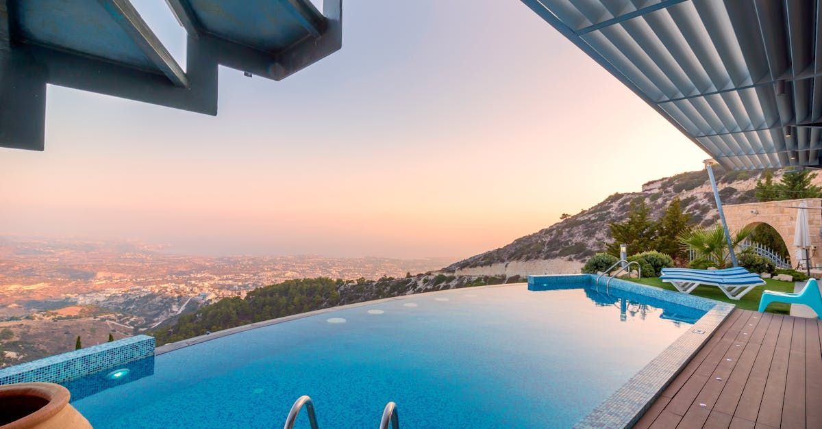 There is a swimming pool with a view of the city.