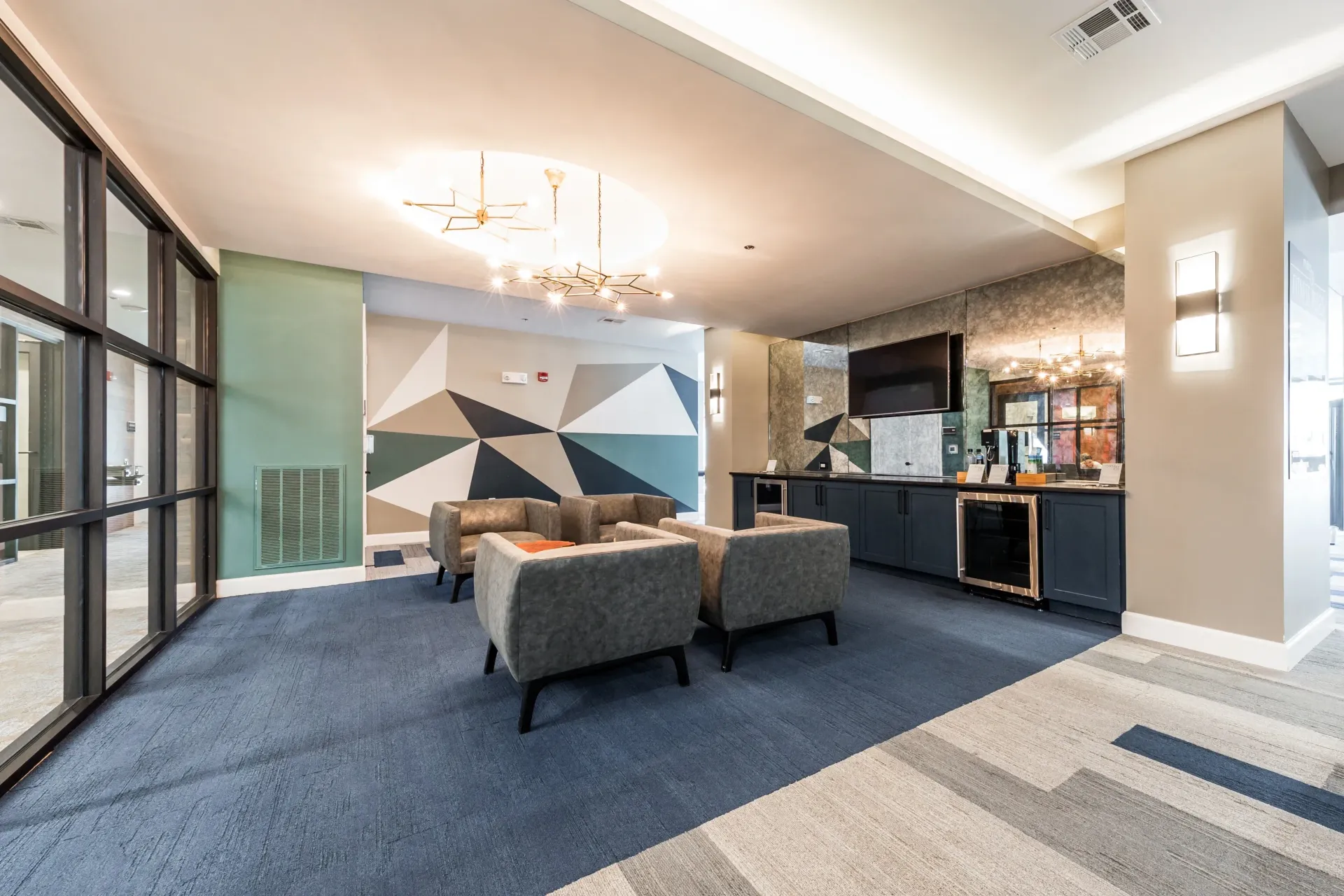 Modern lounge area with plush seating and a stylish wet bar.