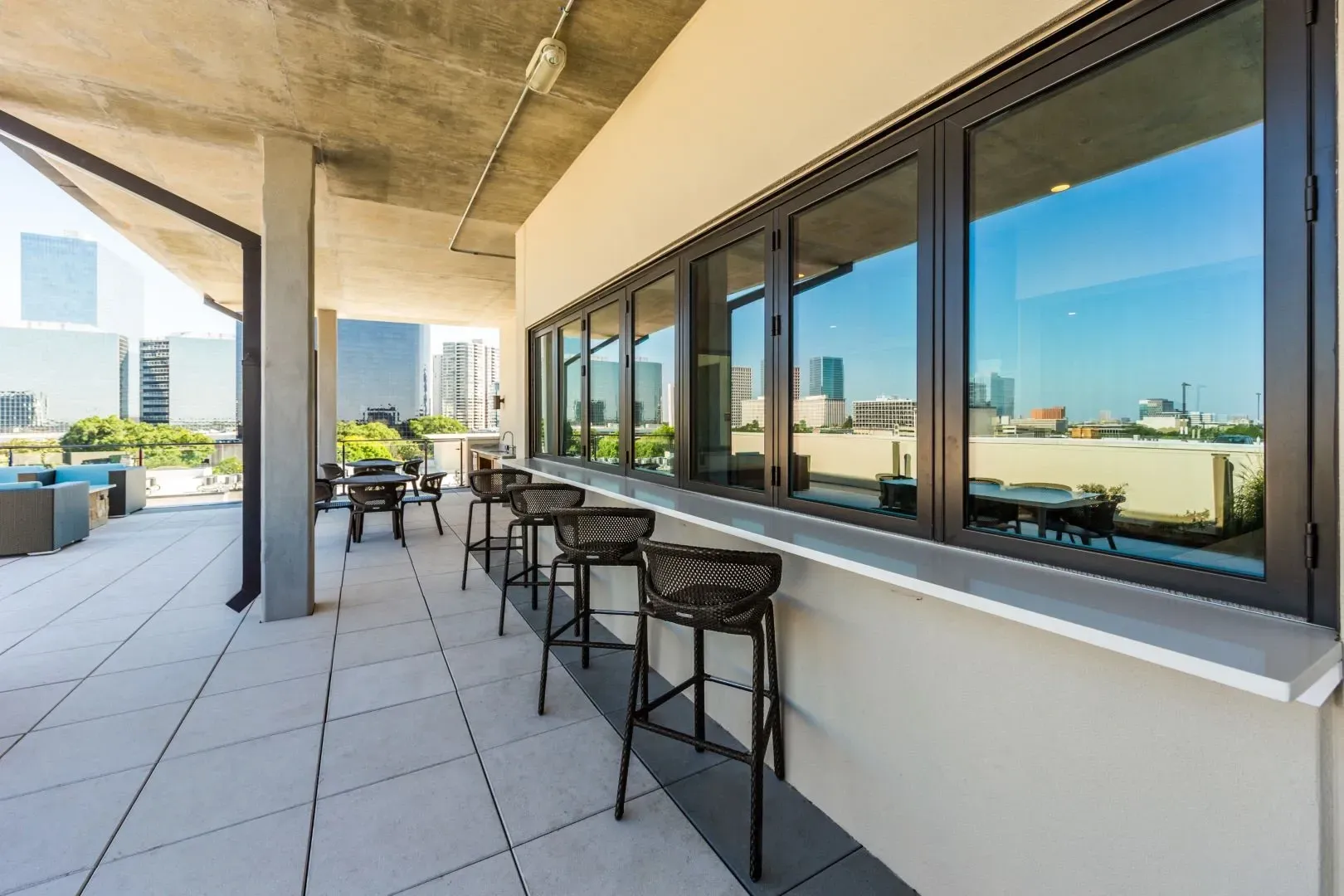 Rooftop bar seating with city skyline view