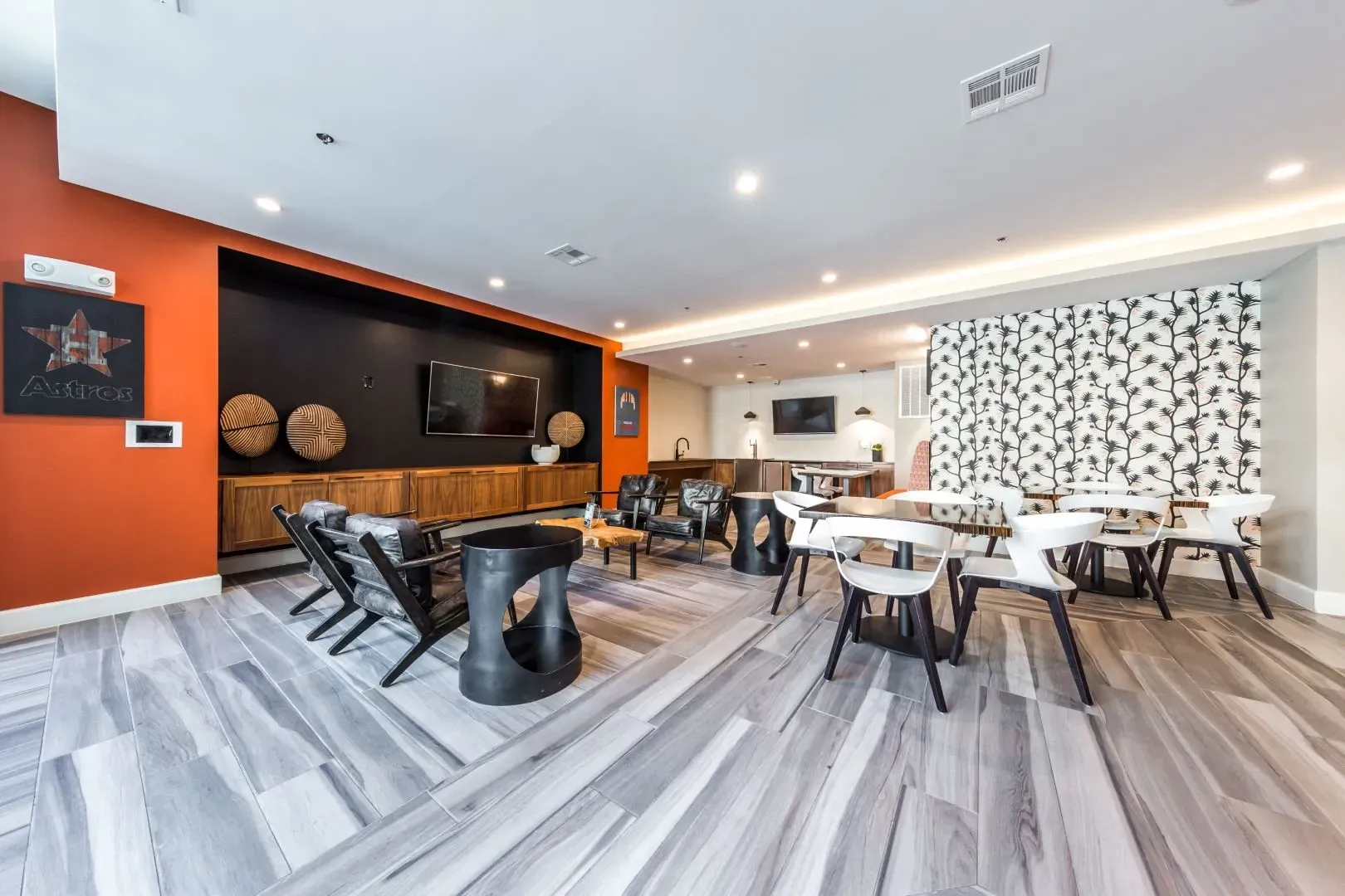 Stylish lounge area with seating, tables, and entertainment.