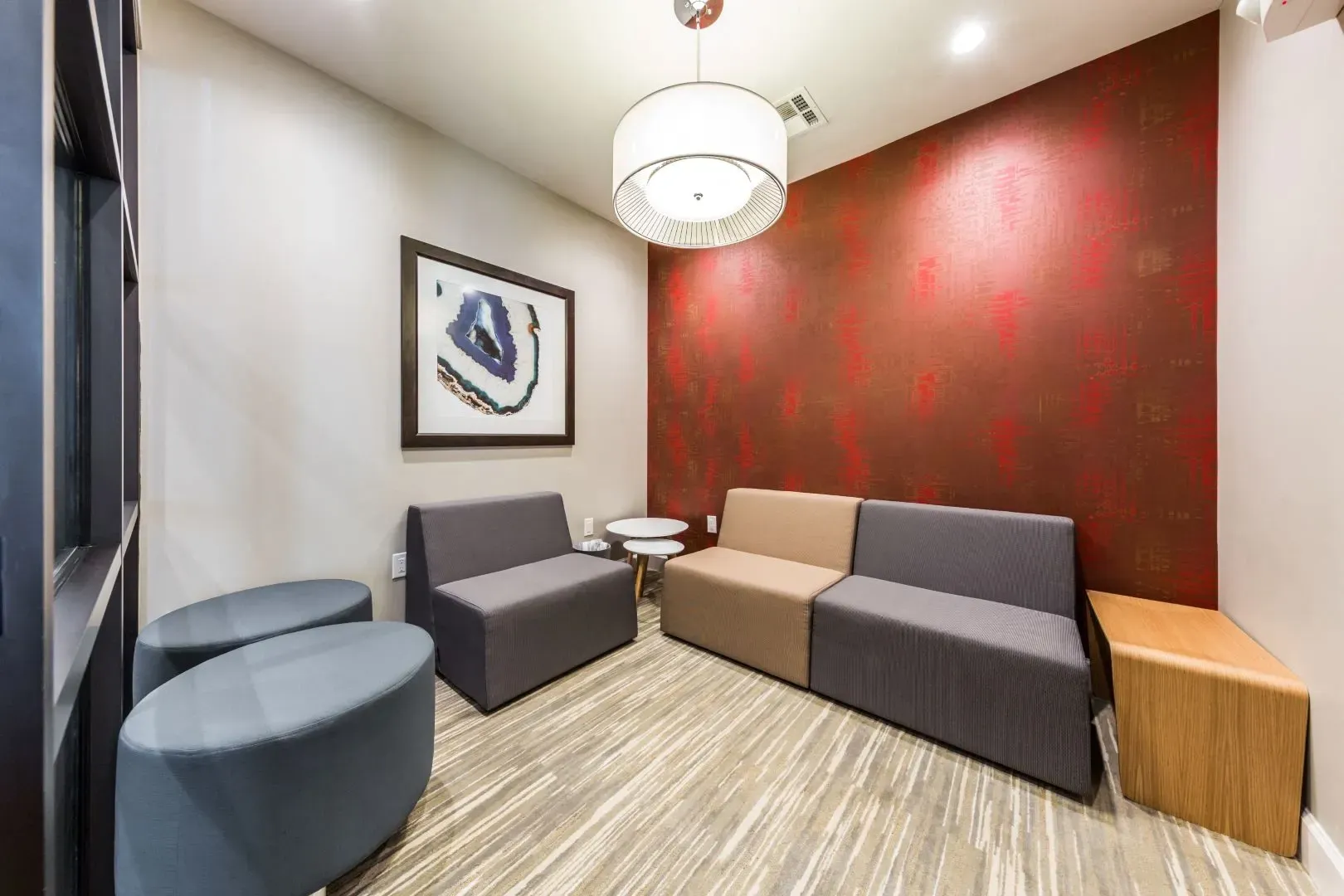 Modern waiting area with abstract art and comfortable seating.