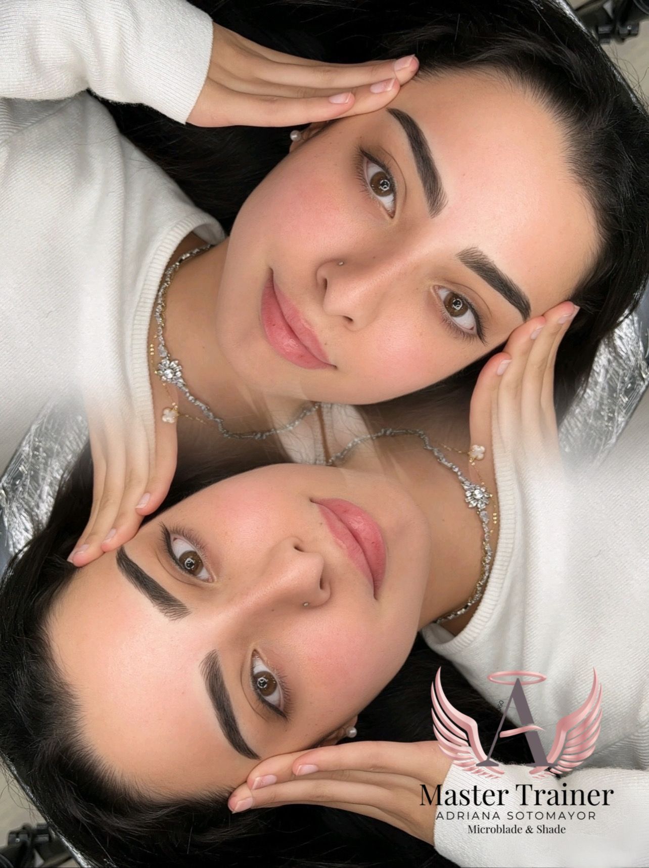 Two women with matching makeup and hands on faces, mirrored reflection.