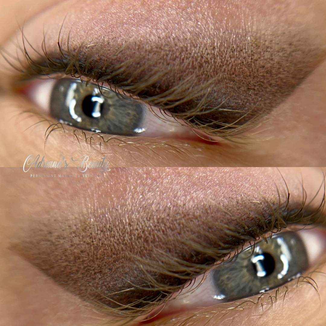Close-up of eye with smoky eyeshadow, reflecting light; a pale skin tone and grey-green iris are visible.