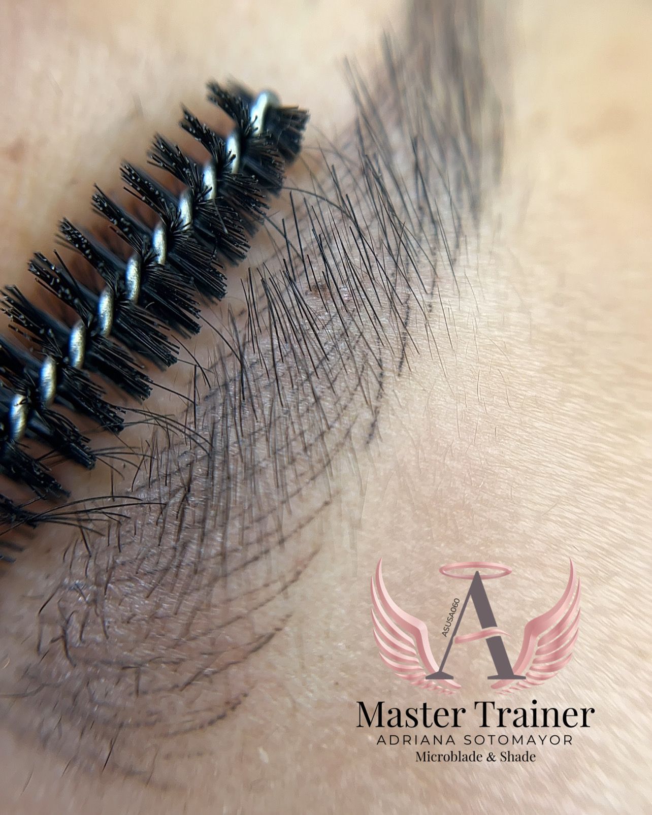 Close-up of an eyebrow being brushed with a black spoolie brush.