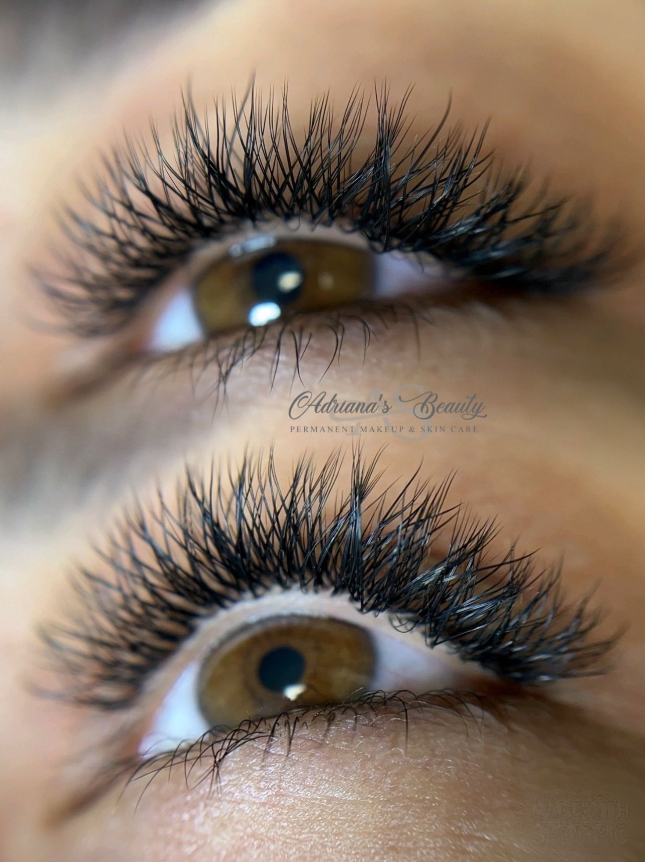 Close-up of two brown eyes with full, dark eyelash extensions.