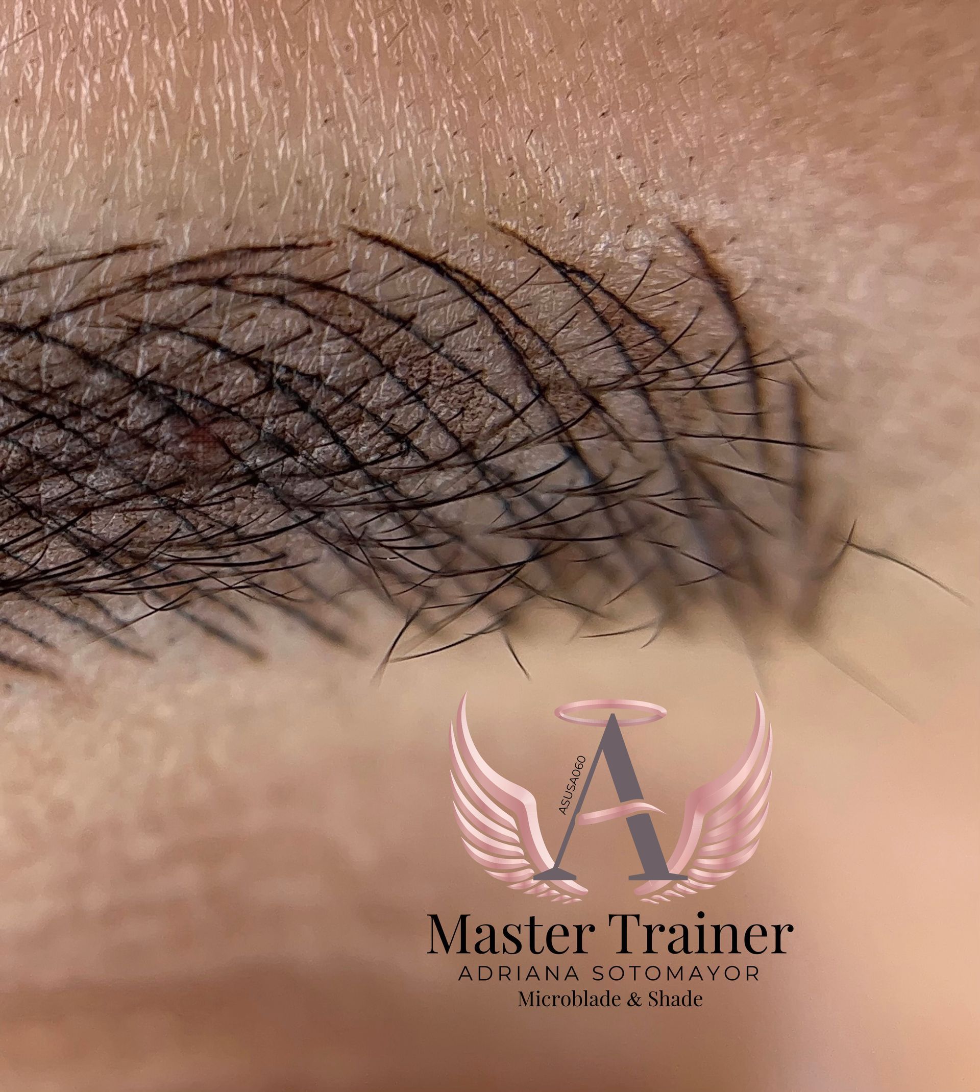 Close-up of eyebrow with hair-stroke microblading, dark color.