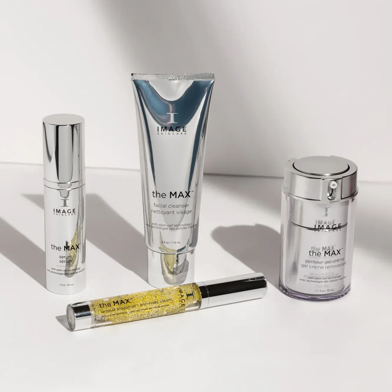 Skincare products in silver containers, against a white background with shadows.