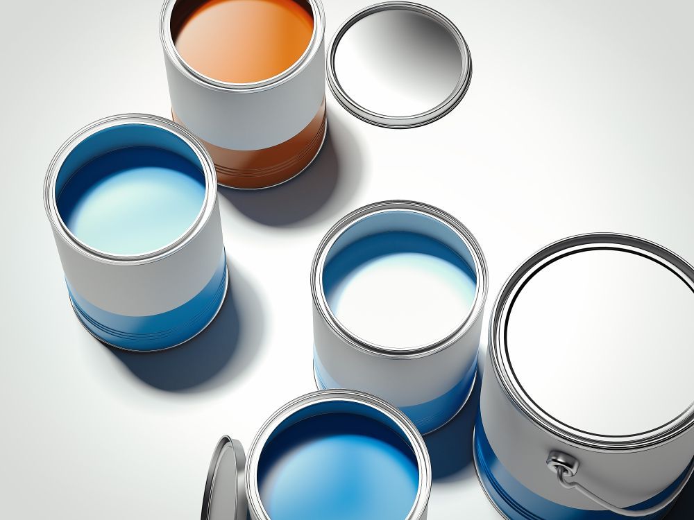 Open paint cans with blue, white, and orange paint on a white surface — Jamie Frankham Painting in Goonellabah, NSW