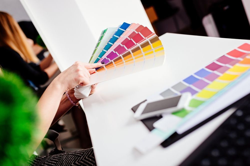A person Holding and Pointing at a Color Swatch Fan — Jamie Frankham Painting in Bangalow, NSW