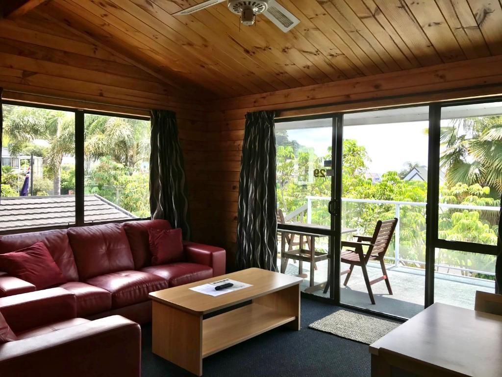 A living room with a red couch and a coffee table