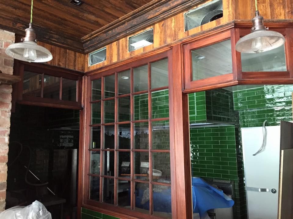A room with a lot of windows and green tiles