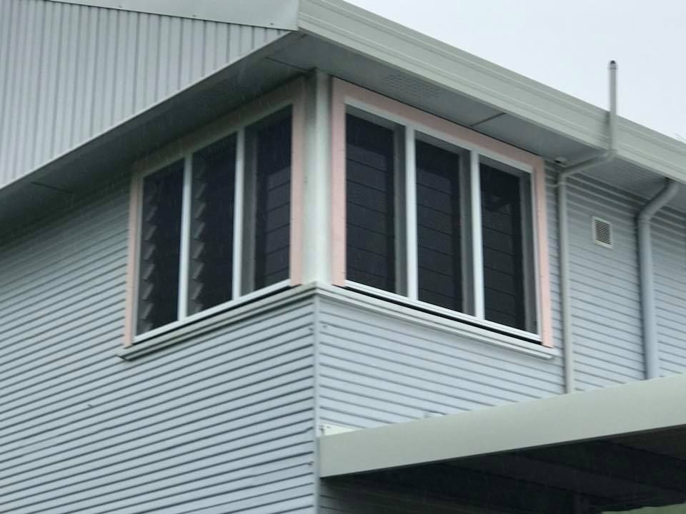A house with a lot of windows on the side of it.