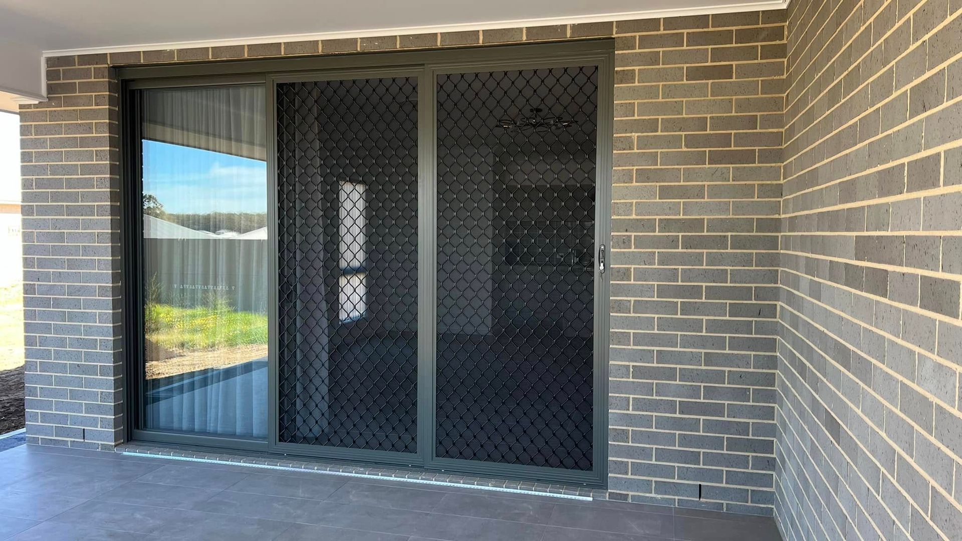 A brick wall with a sliding glass door on it.