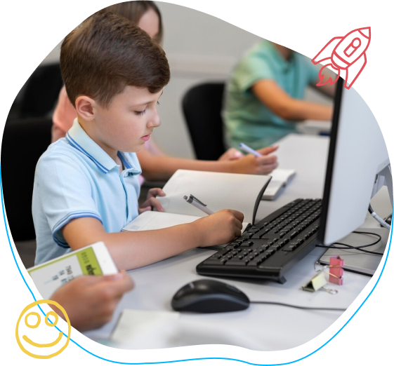 a boy sits in front of a computer