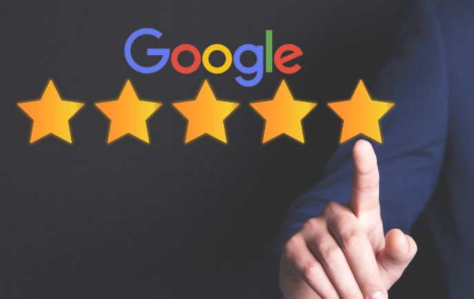 Hand pointing at a five-star rating under a Google logo.