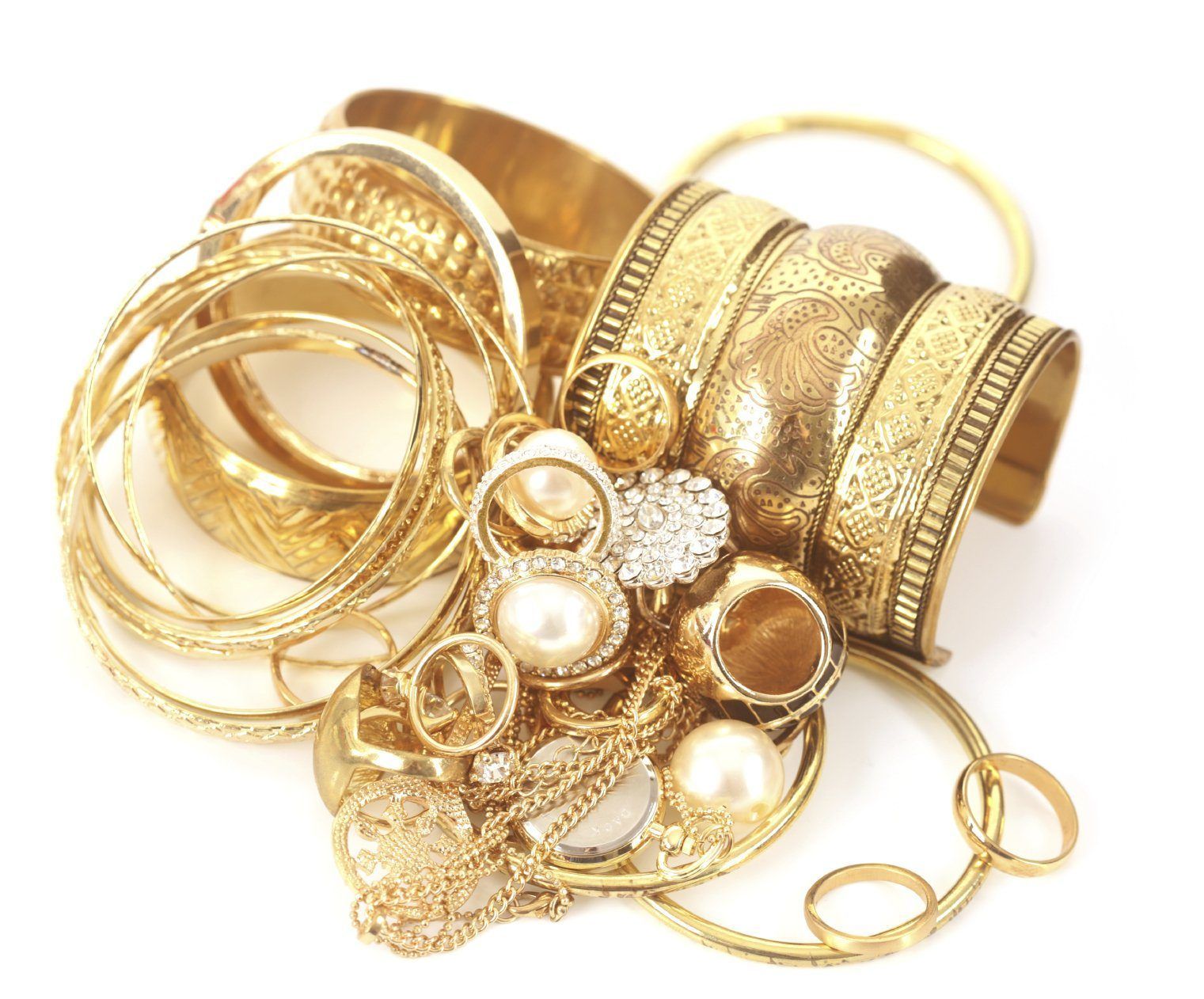 Pile of gold jewelry: bangles, rings, a bracelet, and a necklace on a white background.