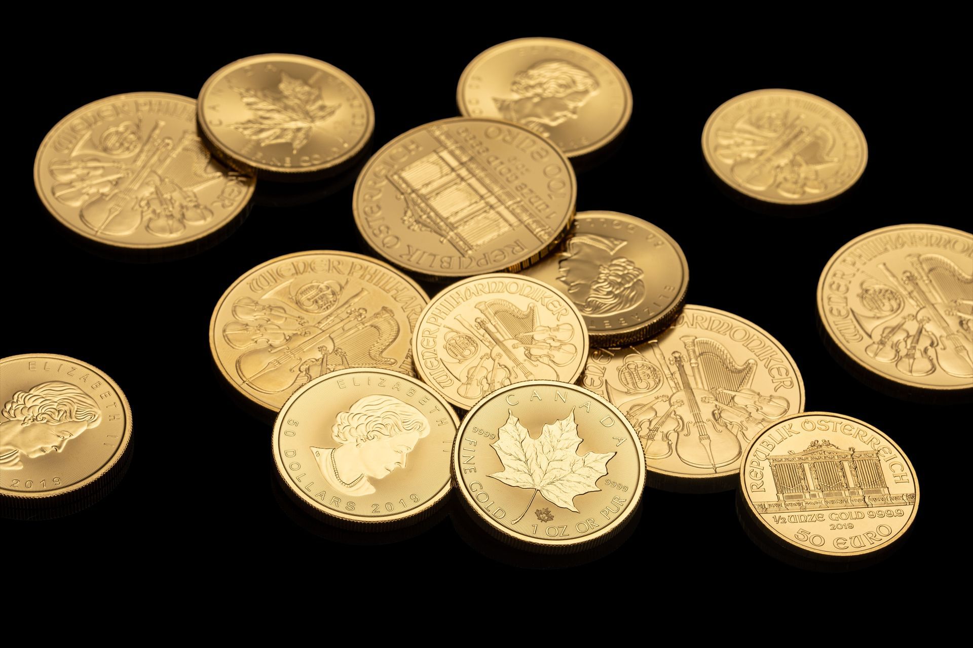 A person stacking gold coins on a surface
