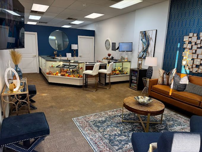 Interior of a jewelry store with display cases, seating, and decorative elements in shades of blue and gold.