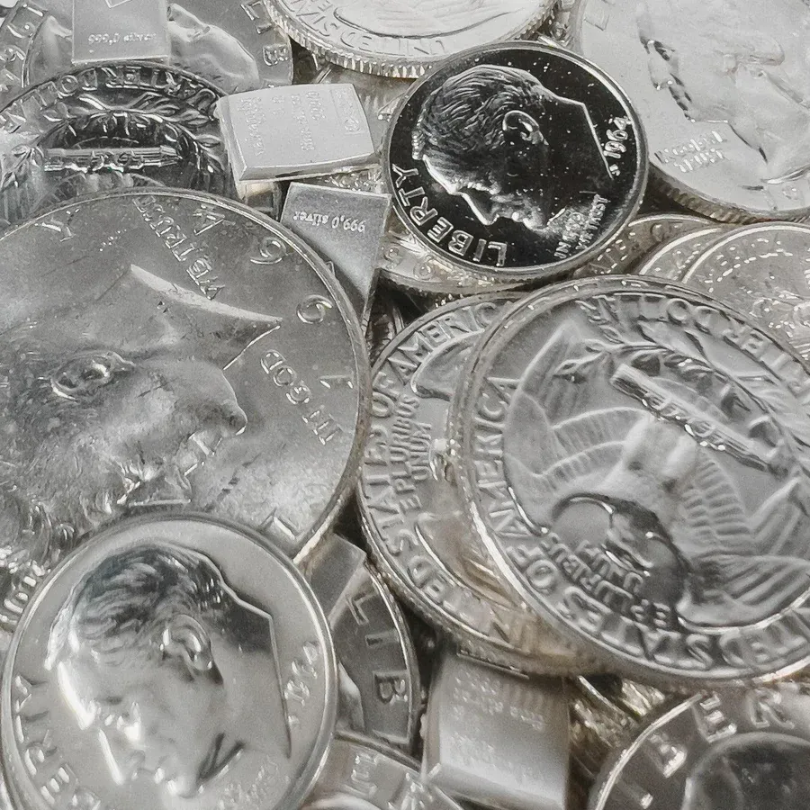 Pile of silver coins, including dimes and quarters.