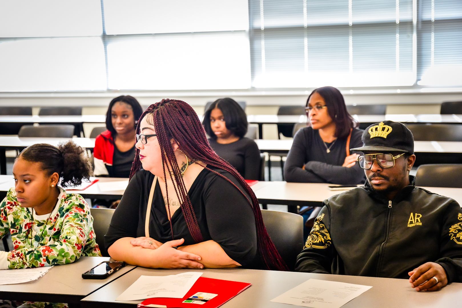 People seated at desks in a classroom.