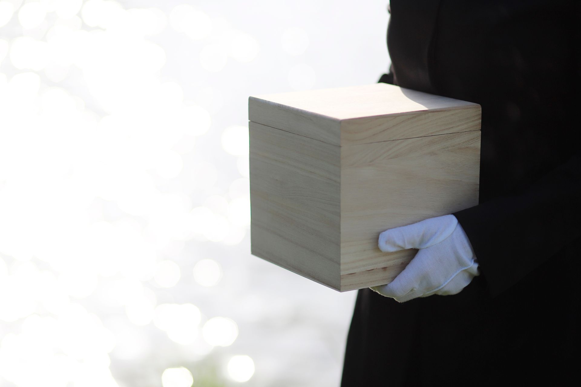 A person is holding an urn with the ashes after the cremation.