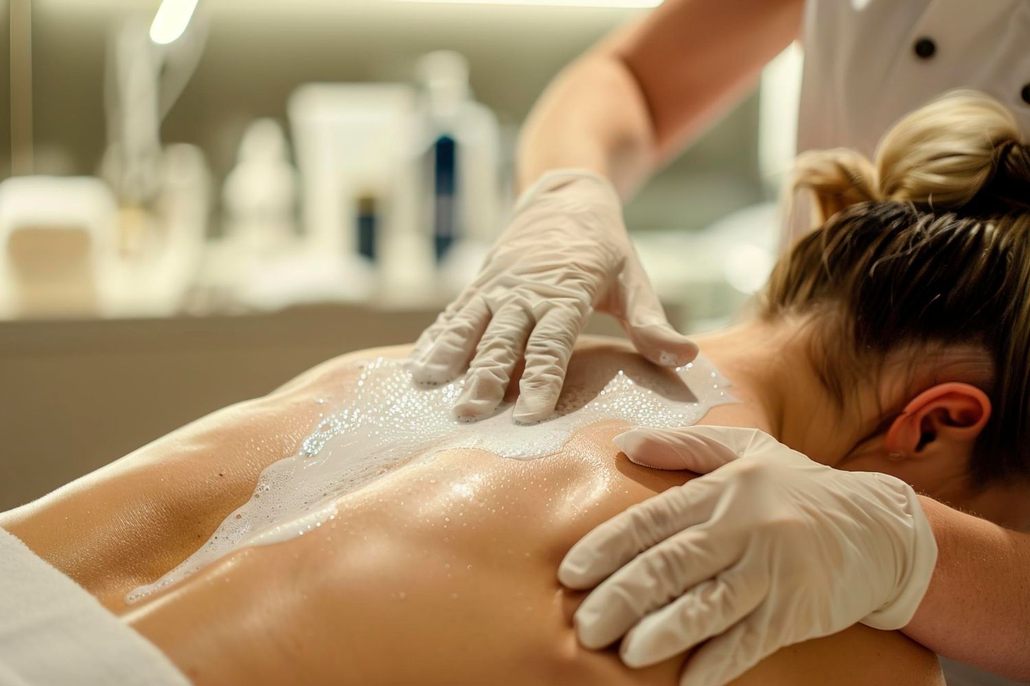 A woman is getting a back massage at a spa.