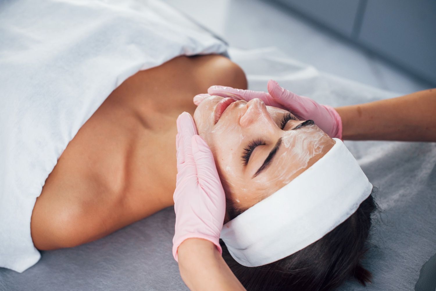 A woman is getting a facial treatment at a spa.