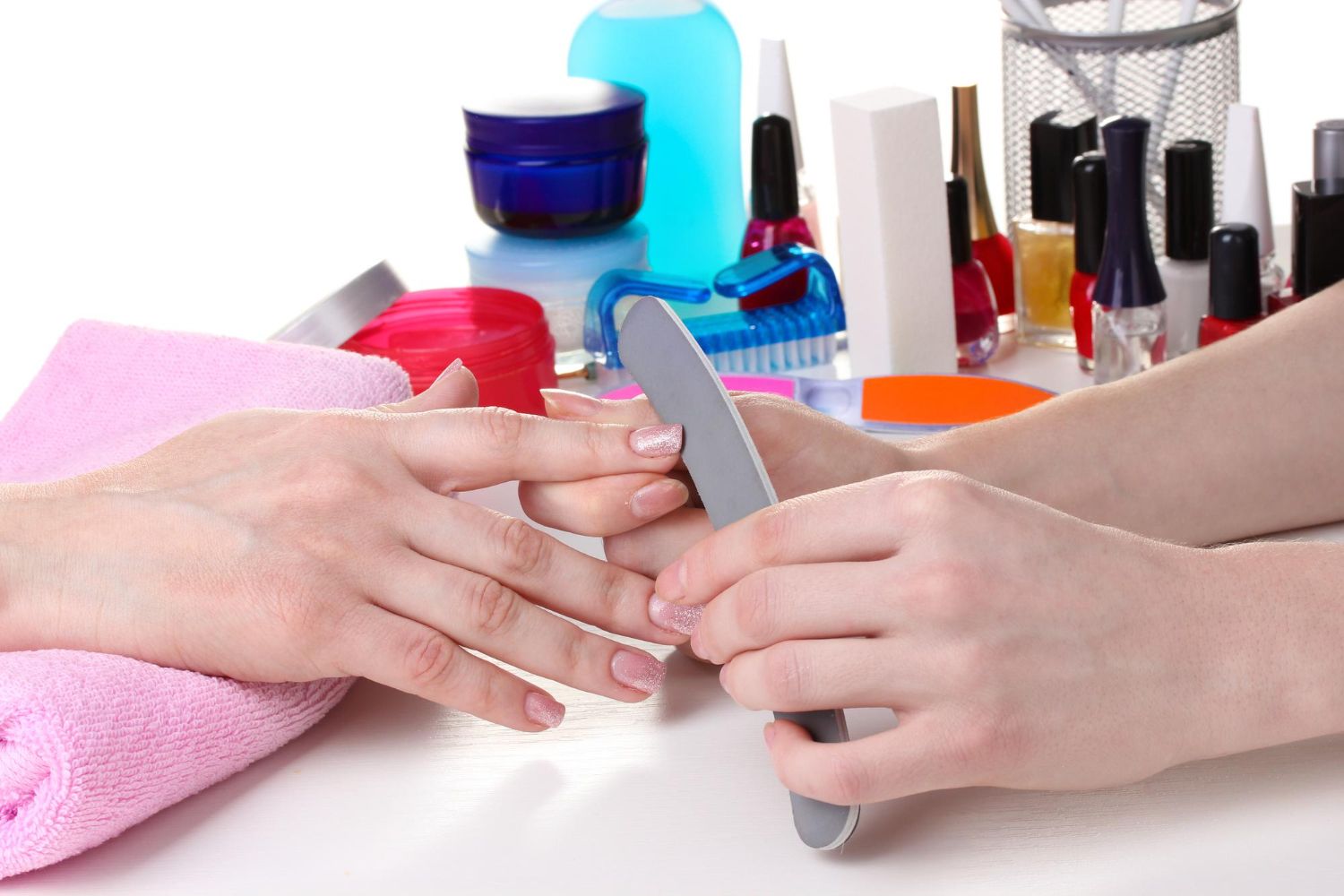 A woman is getting her nails done at a nail salon