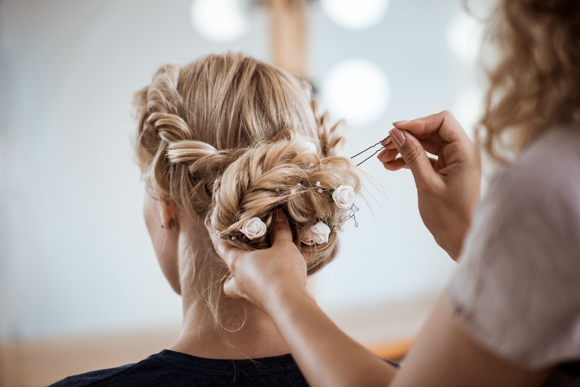 hairdresser making hairstyle for a blonde woman