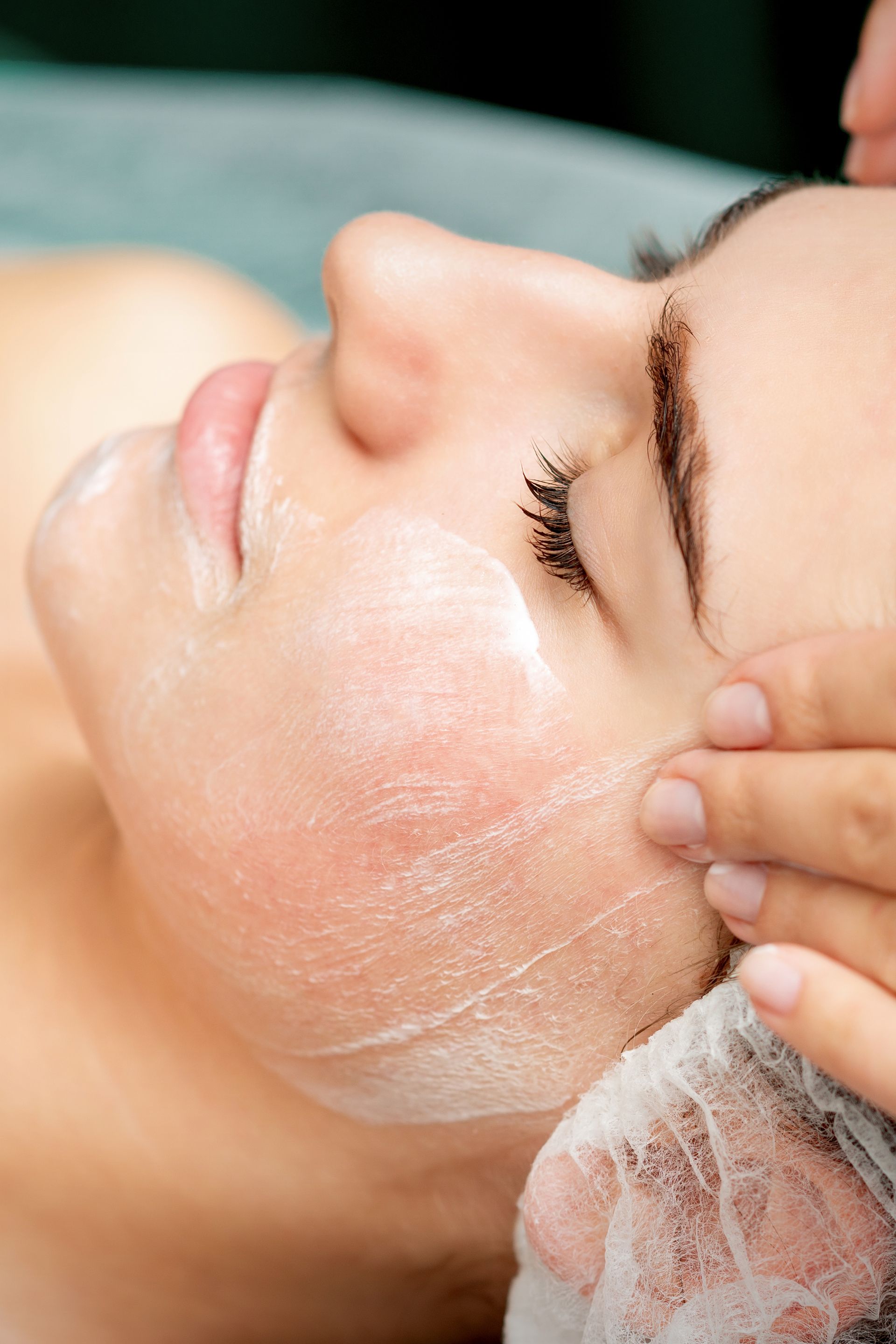 A woman is getting a facial treatment at a spa.